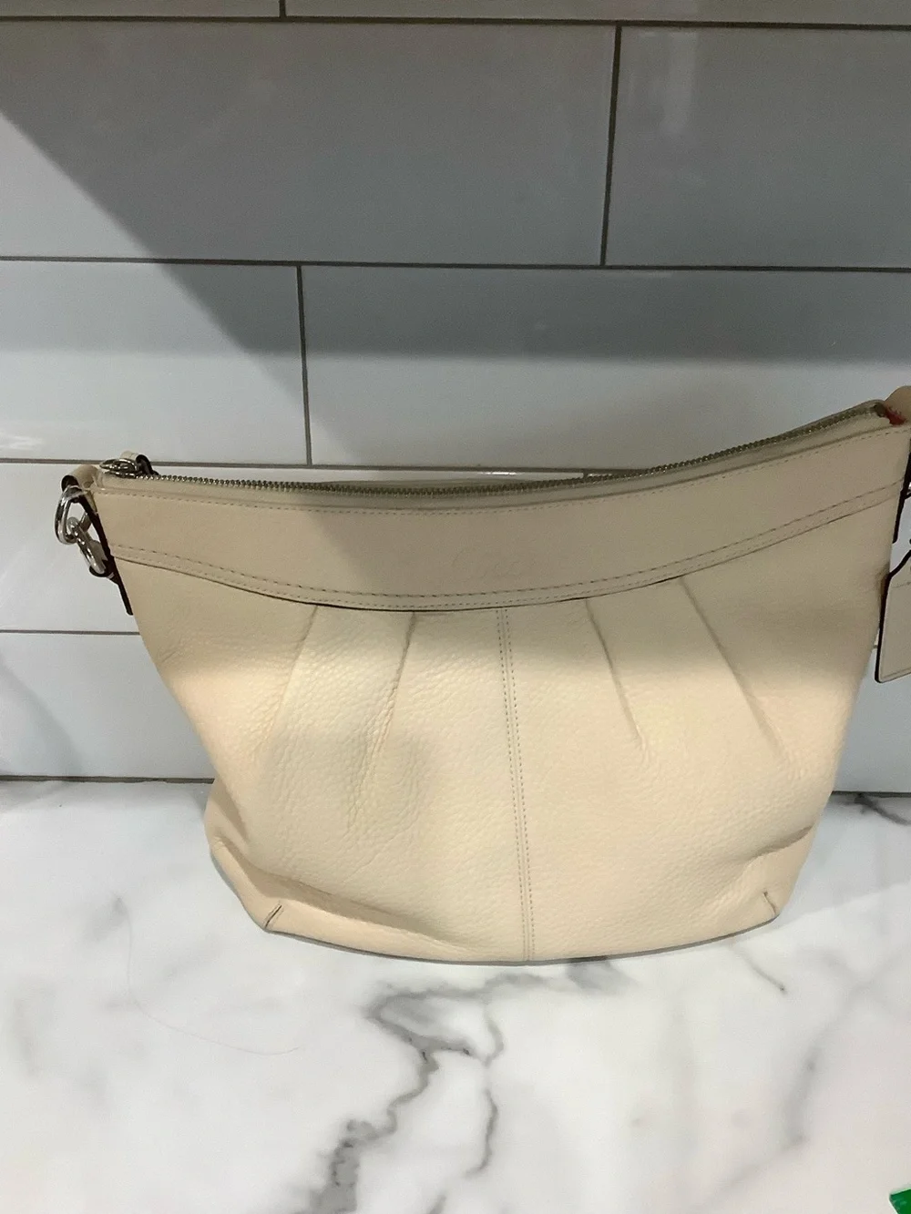 COACH Women's cream colored purse. Crossbody strap also.